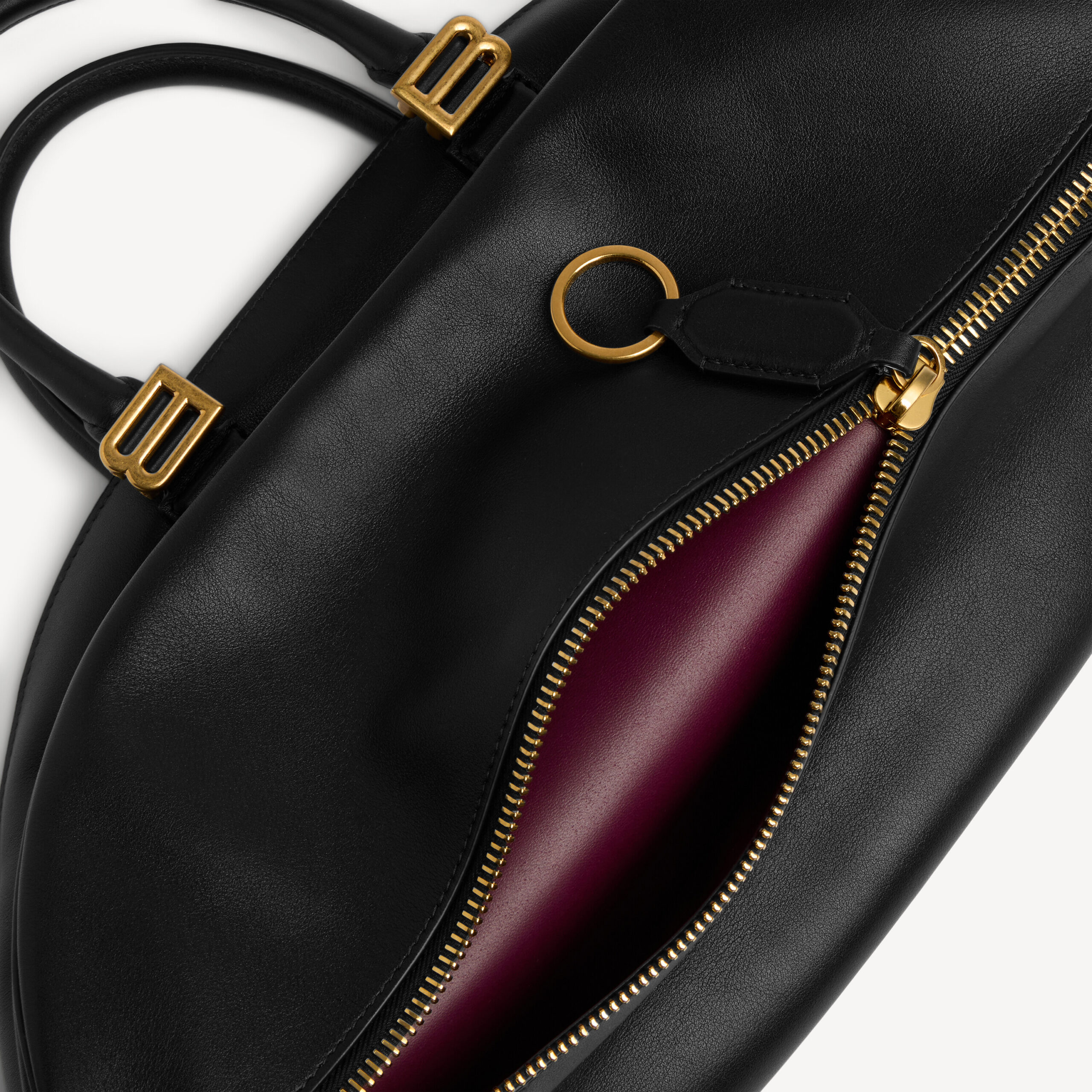 Close-up of B hardware, top zipper and plum lining, $3,950